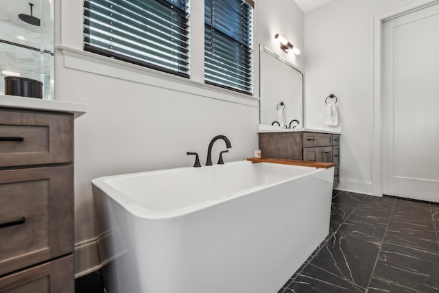 full bathroom with vanity, marble finish floor, a soaking tub, and walk in shower