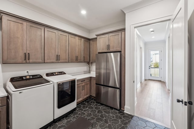 laundry room featuring baseboards, cabinet space, recessed lighting, and washer and dryer