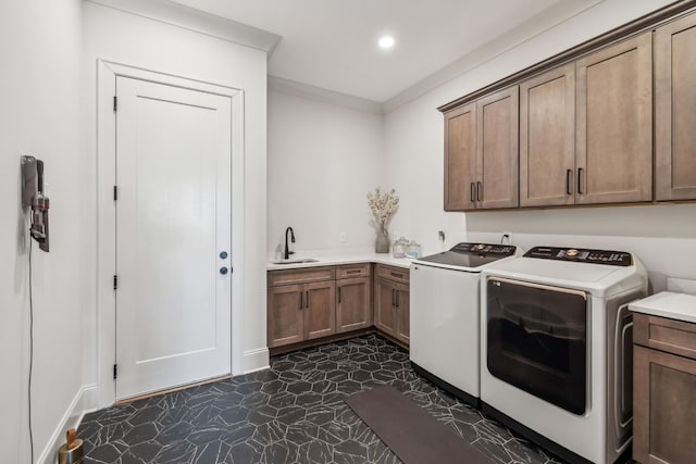 laundry area with washer and clothes dryer, recessed lighting, ornamental molding, a sink, and cabinet space