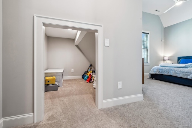 carpeted bedroom with baseboards, vaulted ceiling, and visible vents