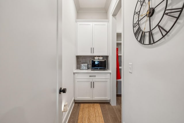 corridor with baseboards and light wood-style floors