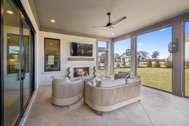 sunroom / solarium with a ceiling fan and an outdoor living space with a fireplace