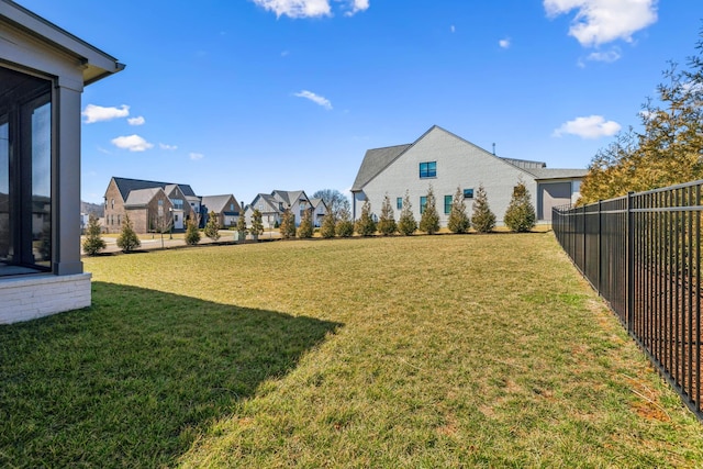 view of yard featuring a residential view and fence