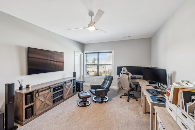 office area featuring baseboards, visible vents, carpet floors, and a ceiling fan
