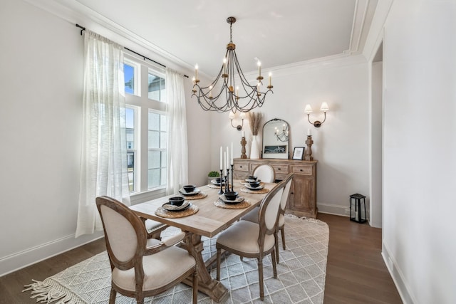 dining room with baseboards, wood finished floors, a chandelier, and crown molding