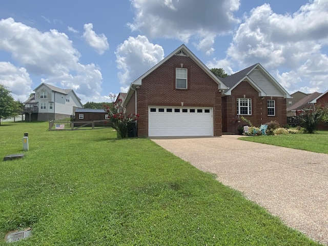 219 Wagoners Way, Westmoreland, TN 37186 - view of front of house with a front lawn, a garage, brick siding, and concrete driveway