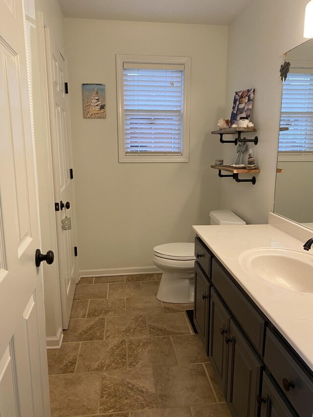 219 Wagoners Way, Westmoreland, TN 37186 - bathroom with stone finish floor, baseboards, toilet, and vanity