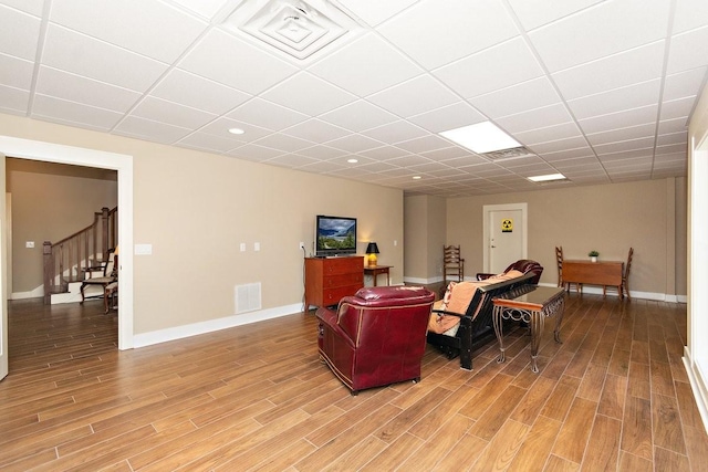 1748 Riverhaven Dr, Adams, TN 37010 - living area with baseboards, stairway, light wood finished floors, and visible vents