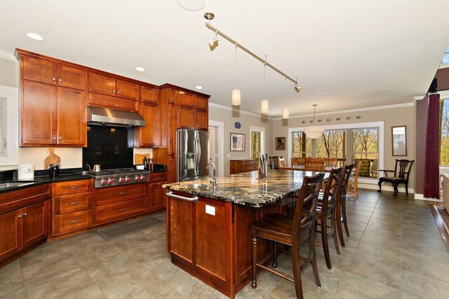 1748 Riverhaven Dr, Adams, TN 37010 - kitchen with a breakfast bar area, exhaust hood, stainless steel appliances, a kitchen island with sink, and ornamental molding