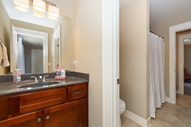 1748 Riverhaven Dr, Adams, TN 37010 - bathroom featuring tile patterned flooring, vanity, toilet, and baseboards