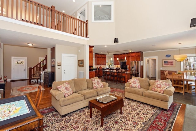 1748 Riverhaven Dr, Adams, TN 37010 - living room featuring stairway, a high ceiling, dark wood finished floors, visible vents, and ornamental molding