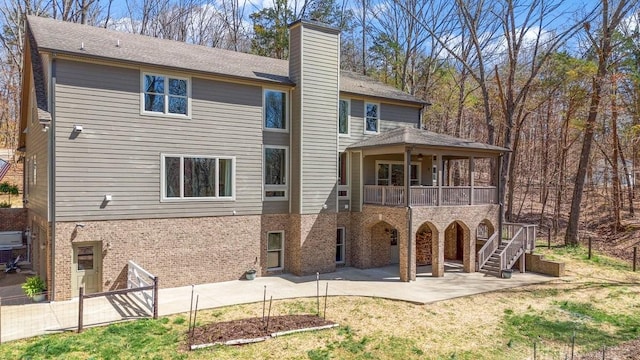 1748 Riverhaven Dr, Adams, TN 37010 - rear view of house featuring a patio area, stairway, a chimney, brick siding, and a yard