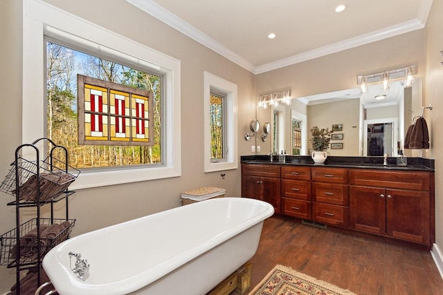 1748 Riverhaven Dr, Adams, TN 37010 - bathroom featuring recessed lighting, ornamental molding, a freestanding bath, double vanity, and wood finished floors