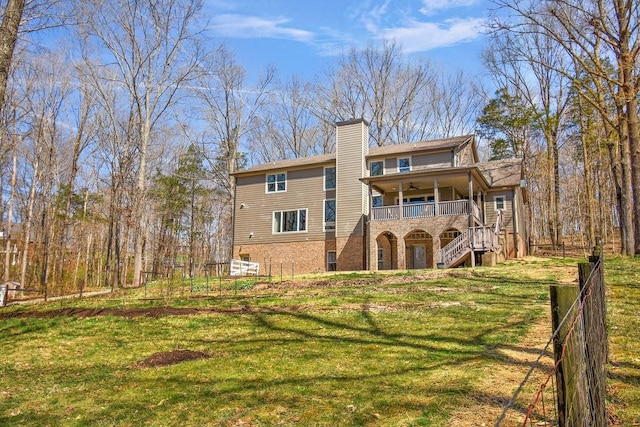1748 Riverhaven Dr, Adams, TN 37010 - back of house featuring fence, stairs, a ceiling fan, a yard, and a chimney