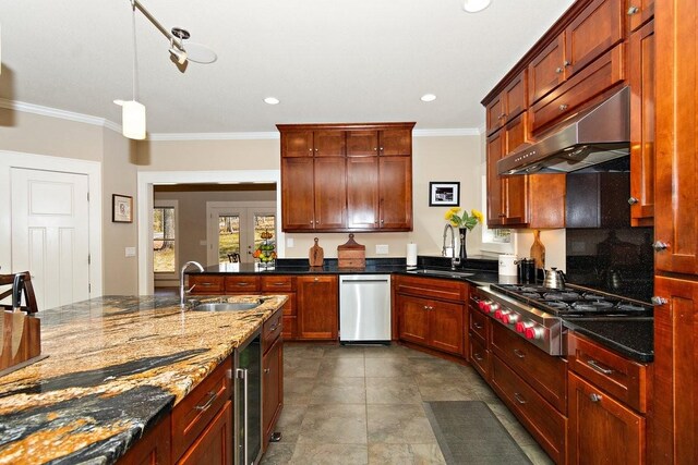1748 Riverhaven Dr, Adams, TN 37010 - kitchen with under cabinet range hood, stainless steel gas cooktop, a sink, and ornamental molding