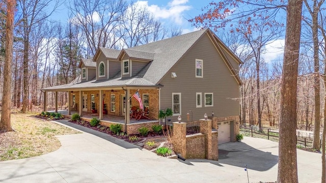 1748 Riverhaven Dr, Adams, TN 37010 - view of home's exterior with a porch, concrete driveway, brick siding, a shingled roof, and a garage