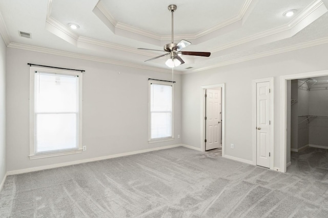 102 Highland Rdg, Hendersonville, TN 37075 - unfurnished bedroom featuring carpet flooring, a tray ceiling, a spacious closet, and crown molding