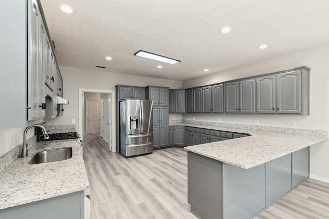 102 Highland Rdg, Hendersonville, TN 37075 - kitchen featuring a sink, stainless steel fridge with ice dispenser, a peninsula, gray cabinetry, and light wood-style floors
