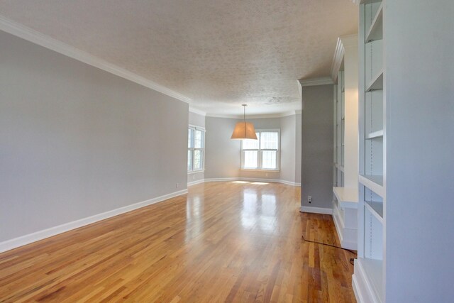 526 Christel Springs Dr, Clarksville, TN 37043 - unfurnished room with crown molding, baseboards, a textured ceiling, and light wood-type flooring