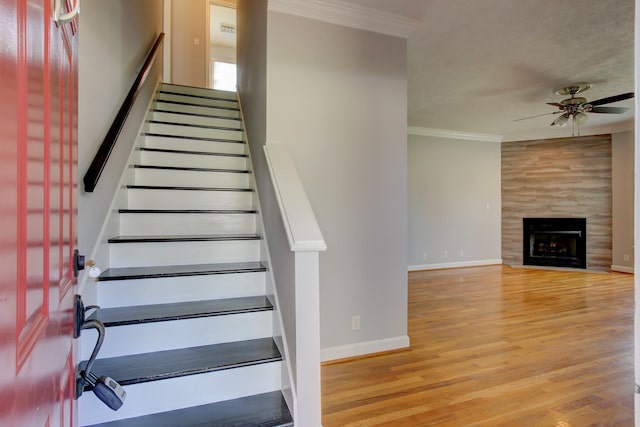 526 Christel Springs Dr, Clarksville, TN 37043 - staircase with ornamental molding, baseboards, a ceiling fan, a tile fireplace, and wood finished floors