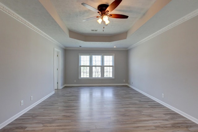 526 Christel Springs Dr, Clarksville, TN 37043 - empty room featuring ornamental molding, baseboards, a raised ceiling, a ceiling fan, and wood finished floors