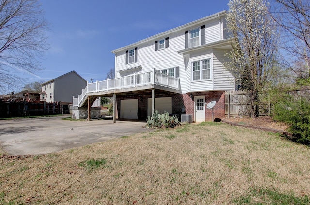 526 Christel Springs Dr, Clarksville, TN 37043 - rear view of house featuring central air condition unit, stairs, a garage, a deck, and brick siding