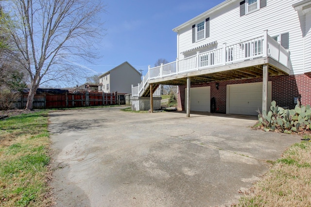 526 Christel Springs Dr, Clarksville, TN 37043 - view of property exterior featuring fence, a garage, stairway, a deck, and driveway