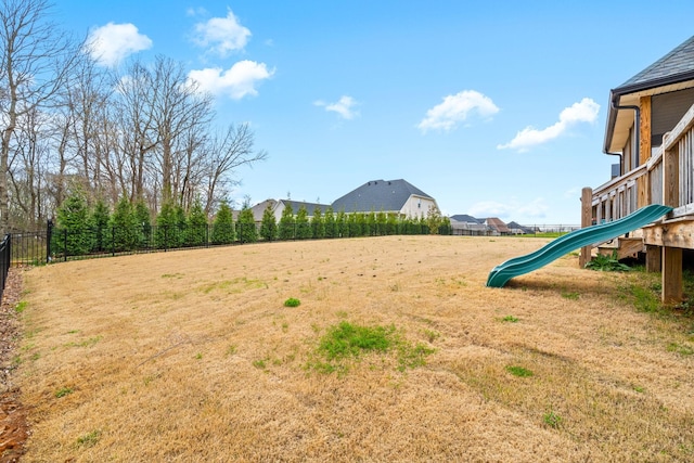 view of yard with playground community and fence