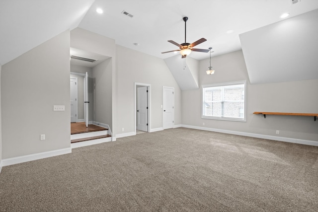 additional living space featuring vaulted ceiling, carpet floors, a ceiling fan, baseboards, and visible vents