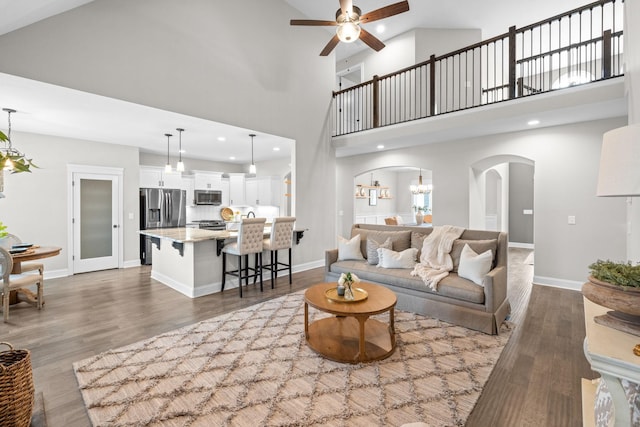 living room with recessed lighting, baseboards, arched walkways, ceiling fan, and wood finished floors