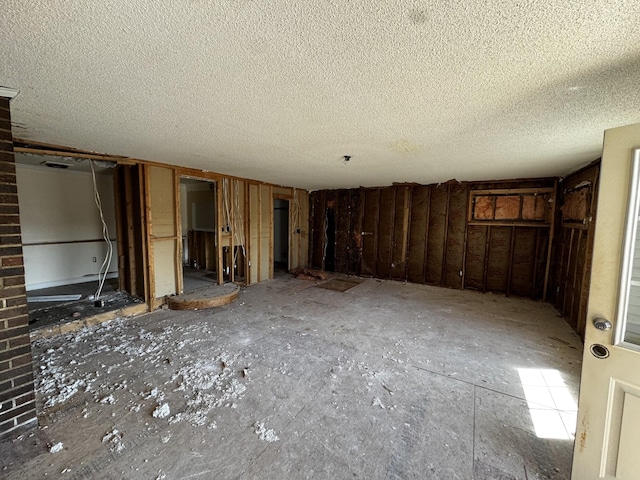 interior space with a textured ceiling