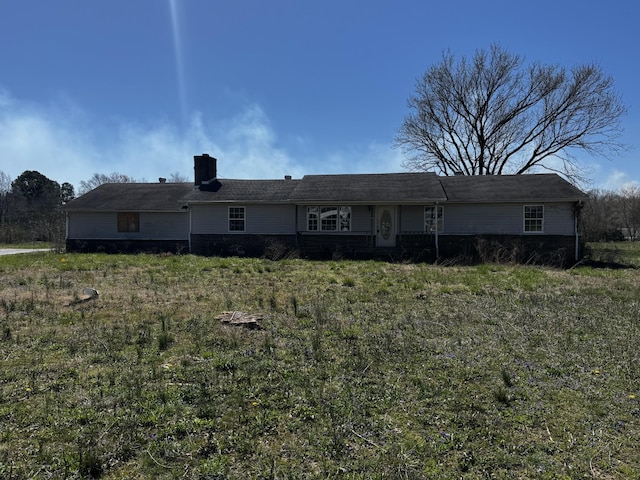 back of house with a chimney