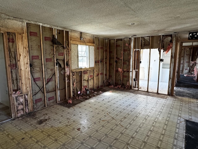 misc room with tile patterned floors and a textured ceiling