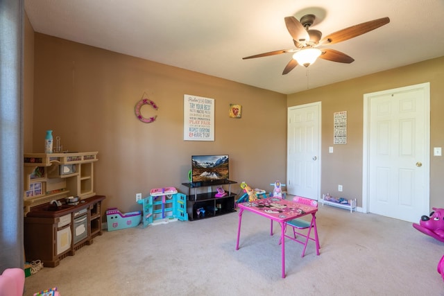 game room with carpet floors and a ceiling fan