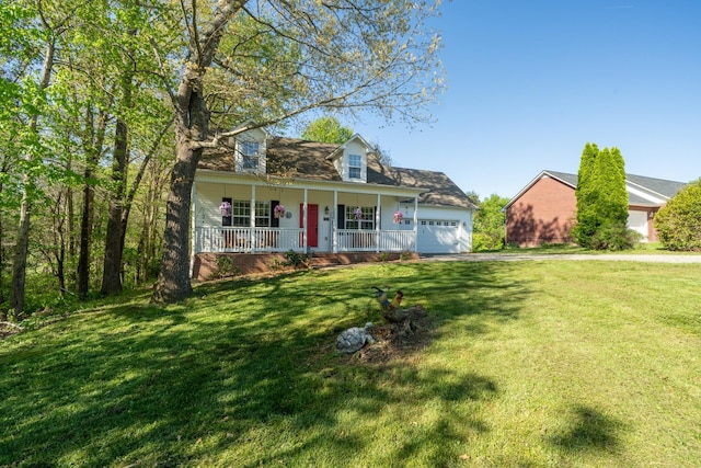 new england style home featuring driveway, a front yard, covered porch, and an attached garage