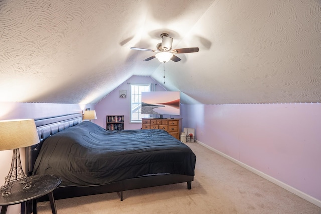bedroom featuring baseboards, lofted ceiling, carpet, and a textured ceiling