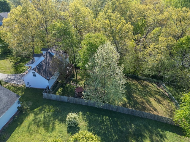 bird's eye view with a wooded view