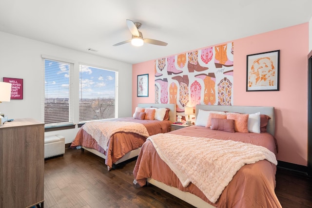 bedroom featuring dark wood-type flooring, baseboards, visible vents, and a ceiling fan