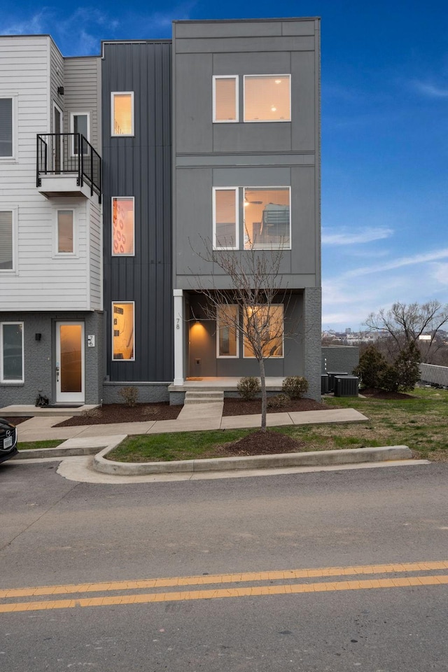 view of front of home with central air condition unit and board and batten siding