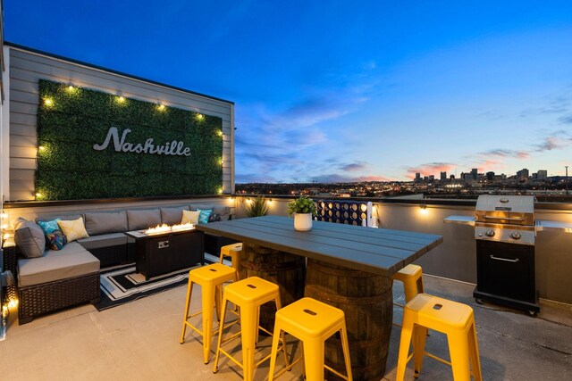 view of patio / terrace featuring an outdoor kitchen, area for grilling, a water view, and an outdoor living space