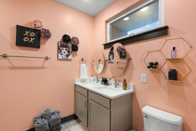 bathroom with toilet and vanity