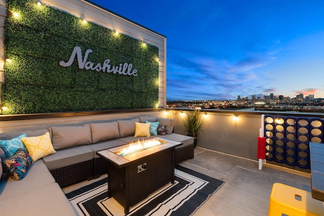 view of patio / terrace featuring a view of city and an outdoor living space with a fire pit