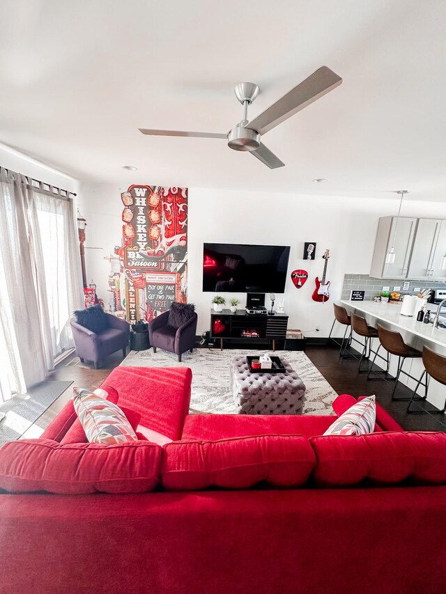 living area featuring wood finished floors and a ceiling fan