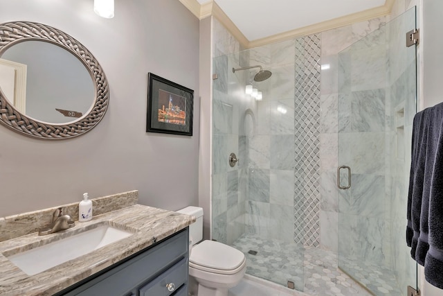 full bathroom featuring ornamental molding, toilet, a stall shower, and vanity