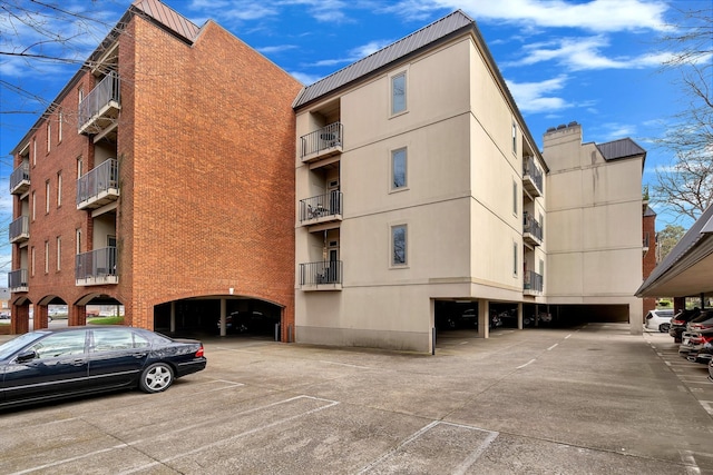 view of building exterior with covered parking