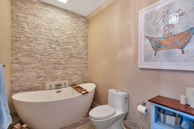 bathroom featuring toilet, crown molding, and a freestanding bath