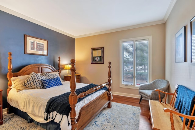 bedroom featuring ornamental molding, baseboards, and wood finished floors