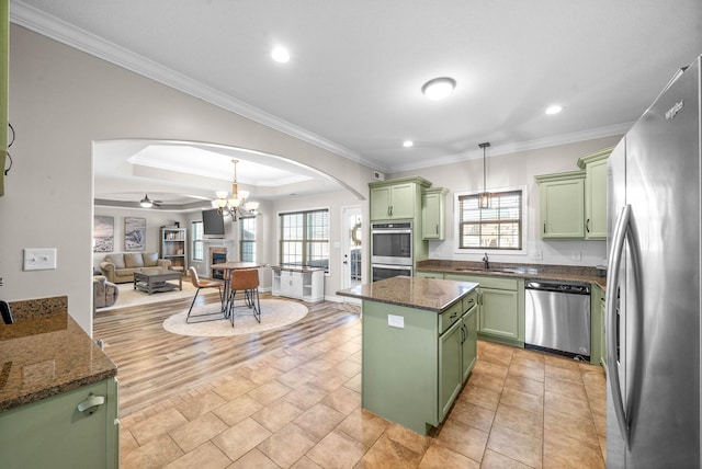 185 Kildeer Dr, Clarksville, TN 37040 - kitchen featuring green cabinets, arched walkways, a sink, and stainless steel appliances
