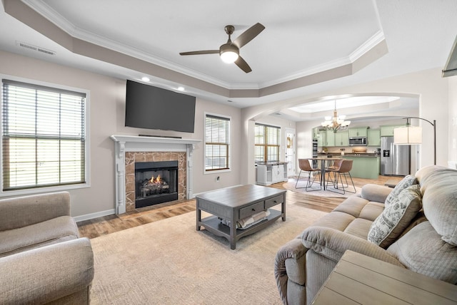 185 Kildeer Dr, Clarksville, TN 37040 - living area featuring arched walkways, light wood finished floors, plenty of natural light, and a raised ceiling
