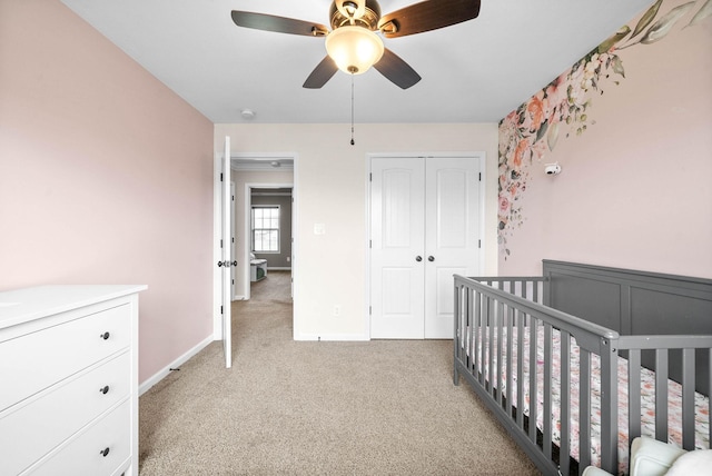 185 Kildeer Dr, Clarksville, TN 37040 - bedroom with a closet, a crib, baseboards, a ceiling fan, and light carpet